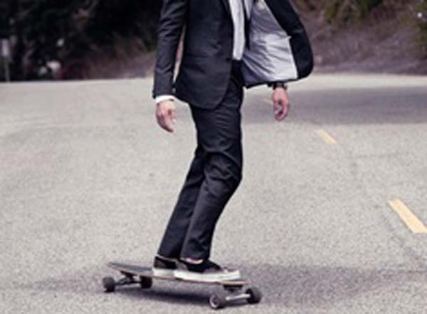 Suit and a guy on a skateboard with trainers