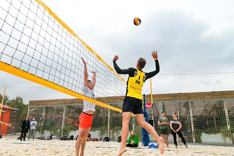 men playing beach volleyball